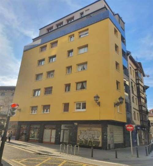 Rehabilitaciones Mendi Bilbao fachada amarilla